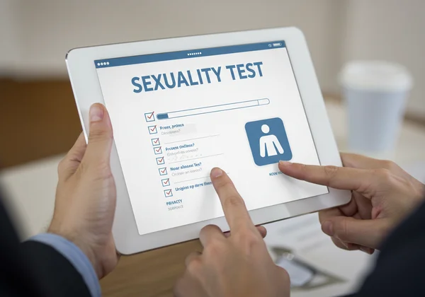 Person taking an online sexuality test on a tablet.